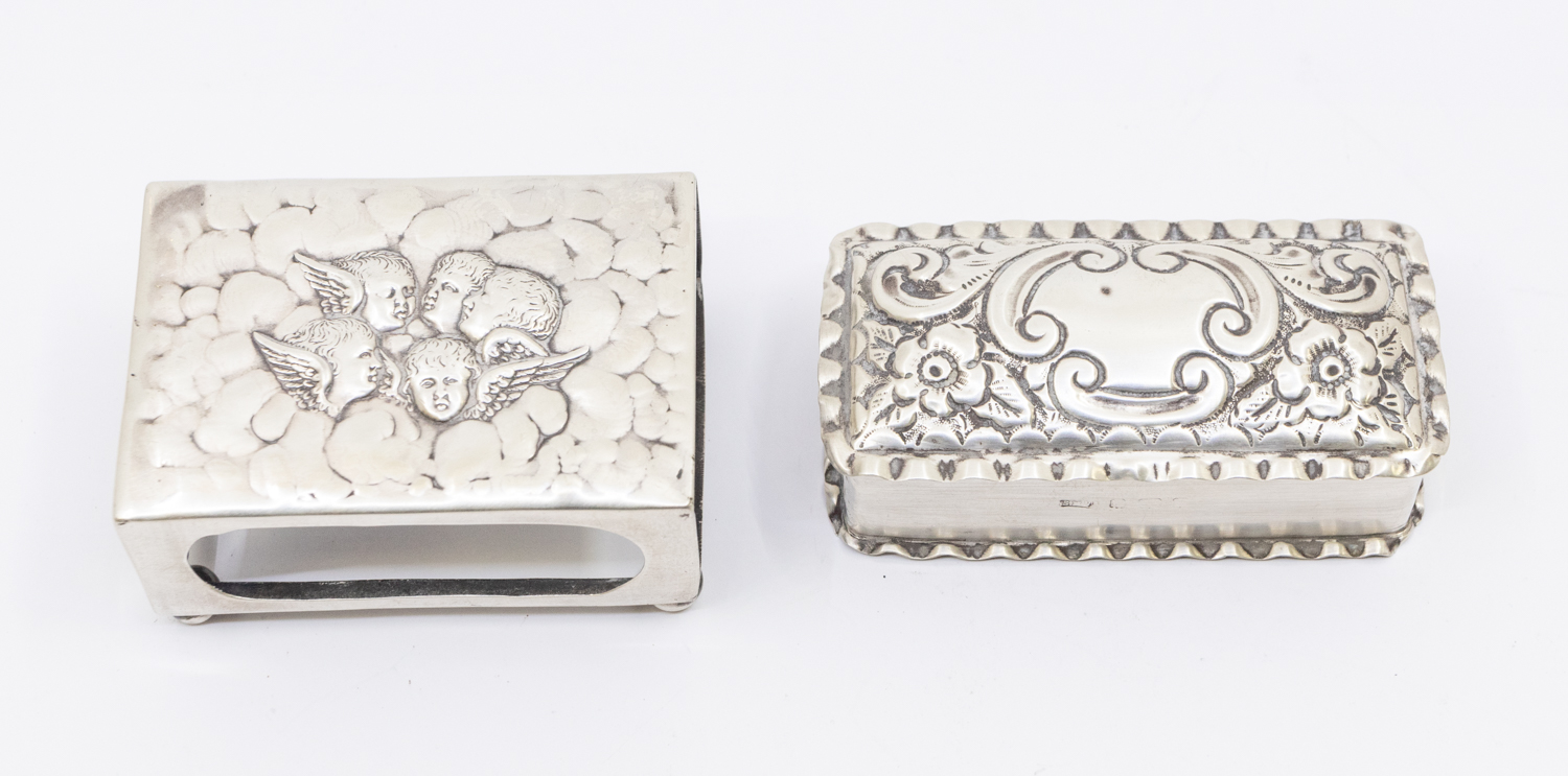 An Edwardian silver matchbox holder, with embossed stylised Reynold's Angels design to top, on