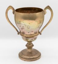 A George V silver twin handled trophy, with circular footed base and knopped stem, unengraved,