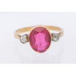 A synthetic ruby and diamond three stone 9ct gold ring, set with an oval ruby approx 9x7mm, single