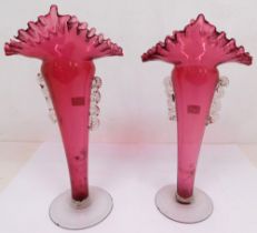 A pair of cranberry mid 20th Century glass vases, chipping to rim