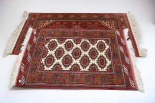 Two mid to late 20th Century hand knotted Iranian rugs with crab medallion detail, reds, greens