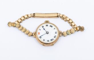 An early 20th century 9ct gold wristwatch with later plated strap a/f damaged glass missing