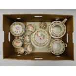 An early 19th century porcelain tea set consisting of tea pot, twin handled sugar bowl, eight tea