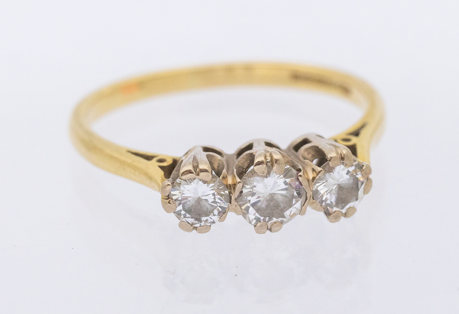 A three-stone diamond and 18ct gold ring, total diamond weight approx 0.60ct, size M, total gross