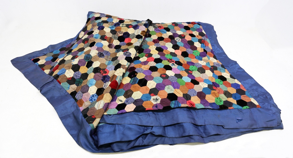 A very unusual silk quilt, c1870/80, hexagon shaped patches in a colourway of blues/gold/cream plain