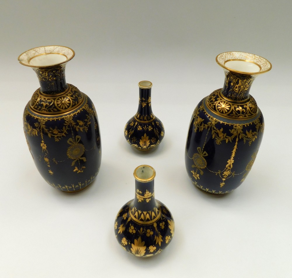 A pair of late 19th Century cobalt blue and elaborate gilt Royal Crown Derby vases along with a pair