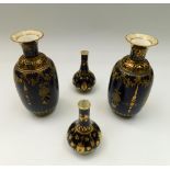 A pair of late 19th Century cobalt blue and elaborate gilt Royal Crown Derby vases along with a pair