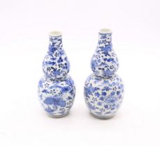 A pair of late 19th century Chinese export porcelain double gourd vases, both with birds, insects