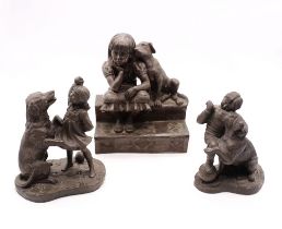 Three bronzed figures of children with dogs.
