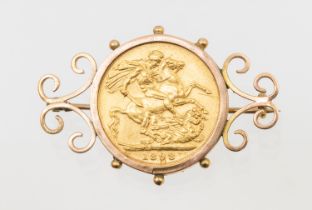 A Victorian sovereign dated 1898, within a 9ct gold scrolled brooch mount, total gross weight approx