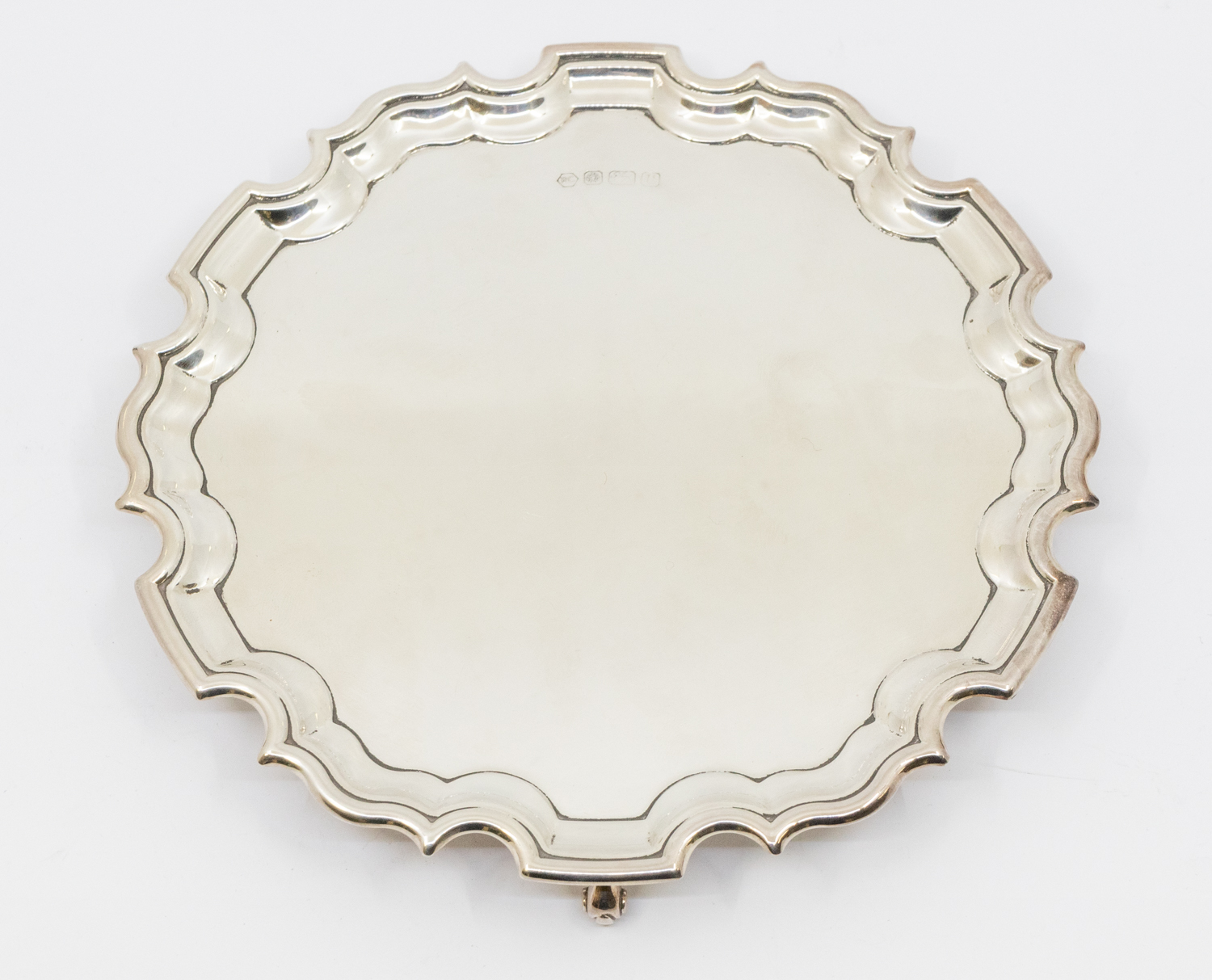 A Modern silver salver, on three scrolled feet, pie crust edging, hallmarked by Carrs, Sheffield,