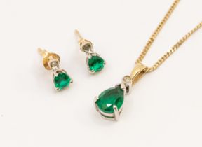 An emerald and diamond pear shaped pendant, length approx 16mm, suspended from a fine 9ct gold