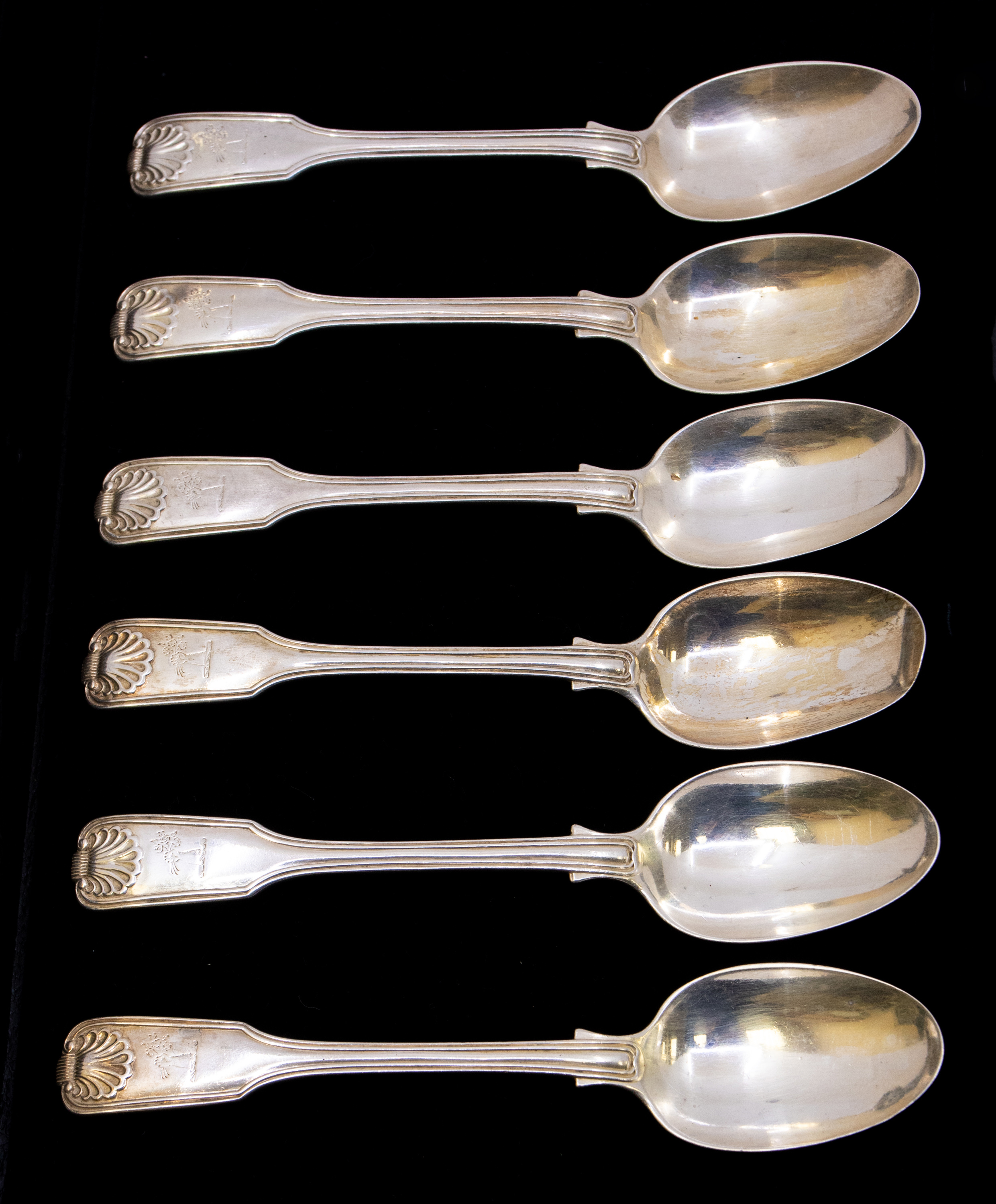 A set of six Victorian silver dessert spoons in the fiddle, thread and shell pattern, each