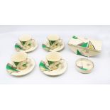 Crown Devon - A collection of Art Deco pieces to include; four cups and saucers, a circular pin/