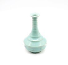 A blue glazed Jun-ware flask shaped bottle vase with light brown crazing, several bosses and five