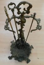 Early 20th Century brass stick stand with hunting dog and rifle detail along with fire irons.