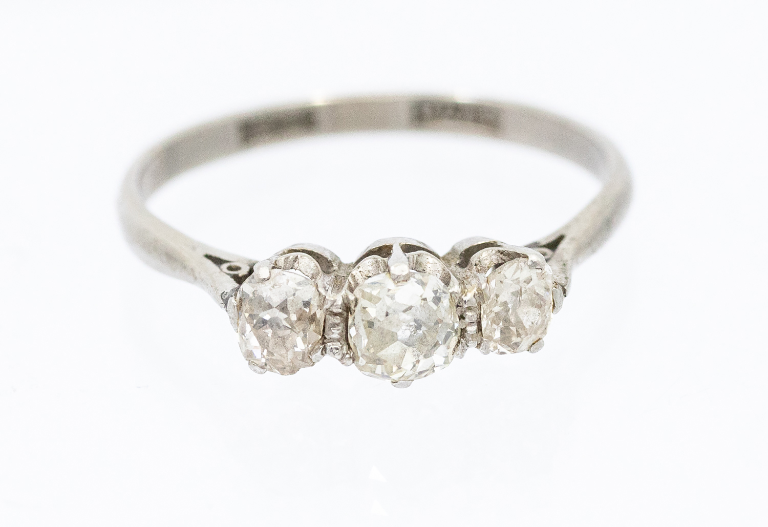 A three stone diamond and 18ct white gold and platinum ring, comprising three graduated old cut