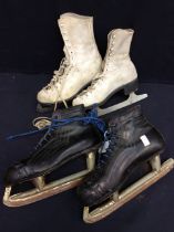 Two pairs of 20th century ice skating shoes with blades, one white, other black colourways.