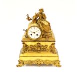 A 19th century French table clock, gilt brass with lady figural decoration to top next to circular