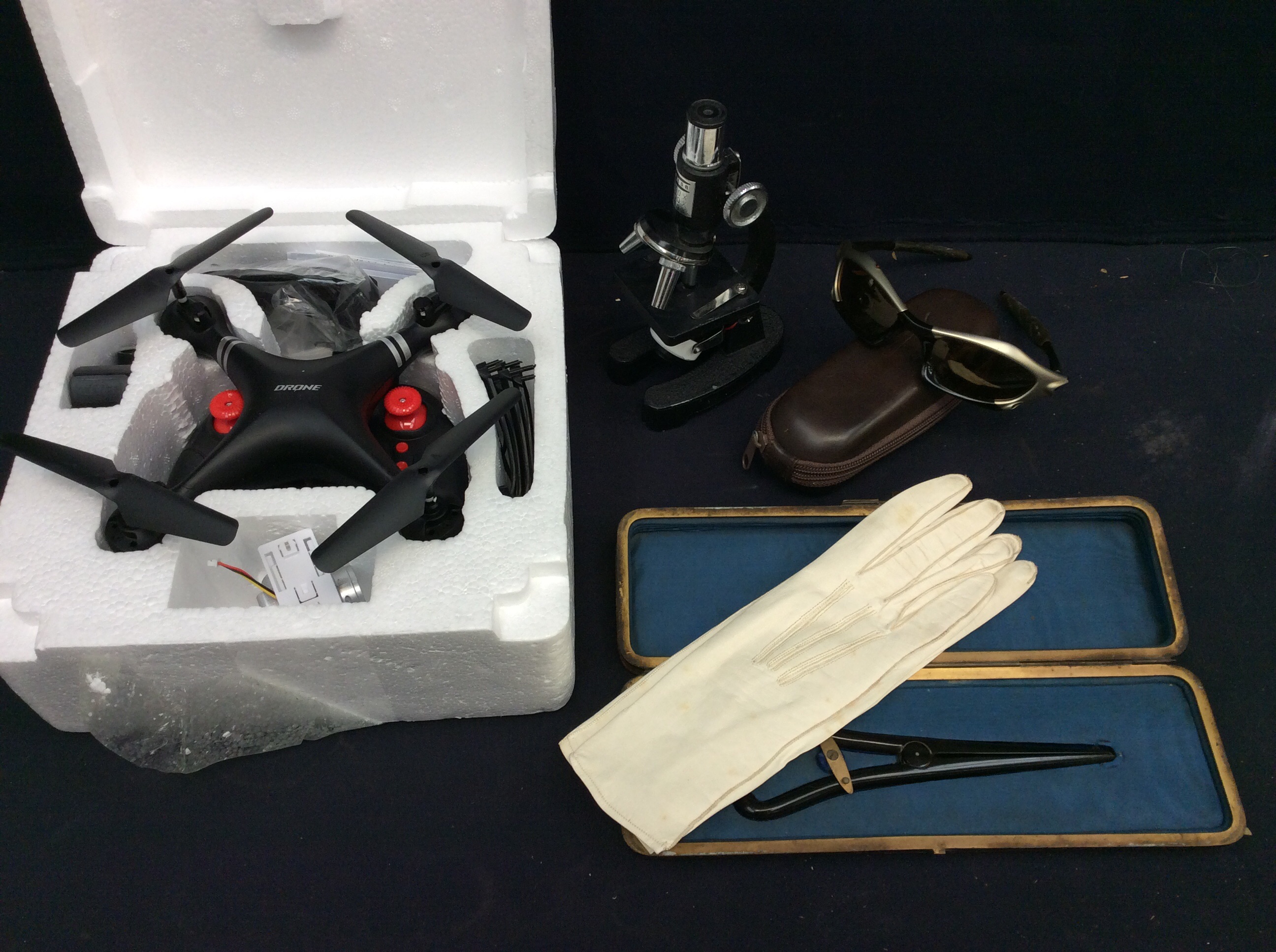 A mixed lot to include; a Tacon small microscope, an early 20th century cased glove and glove