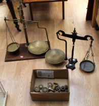 Two late 19th Century table scales on stands with weights, one on mahogany stand other cast iron.