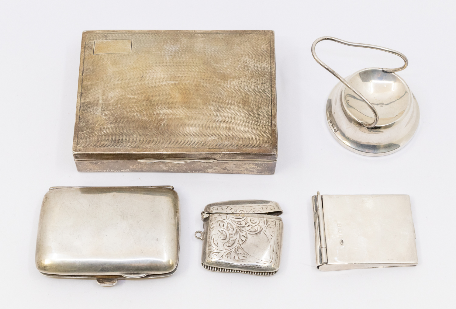 A collection of silver items to include; a small rectangular engine turned silver cigarette box,