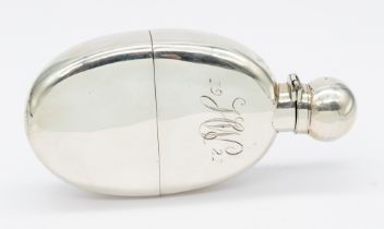 A late Victorian silver hip flask, oval shape with hinged top, removable silver cup, body