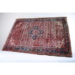 A large mid 20th Century South Western Persian hand knotted rug, reds and blues with crab border