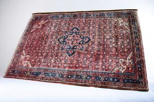 A large mid 20th Century South Western Persian hand knotted rug, reds and blues with crab border