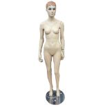 A female mannequin on a chrome stand in good condition.