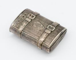 A Victorian novelty silver vesta case, of oval shape with engine turned decoration and buckle relief