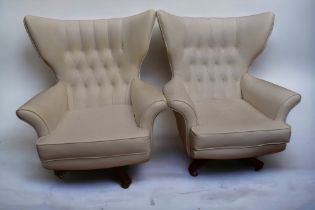 A pair of 1960s/70s cream leatherette 'Blofeld' chairs (possibly G Plan) with button backs,