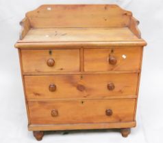 A Victorian pine wash stand with back rail/splash with two above two drawers, knob handles.