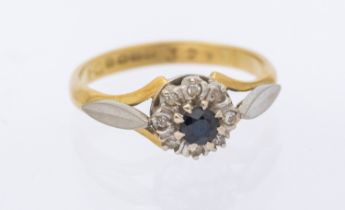 A sapphire and diamond 18ct gold cluster ring, platinum set, width approx 6mm, size L, total gross