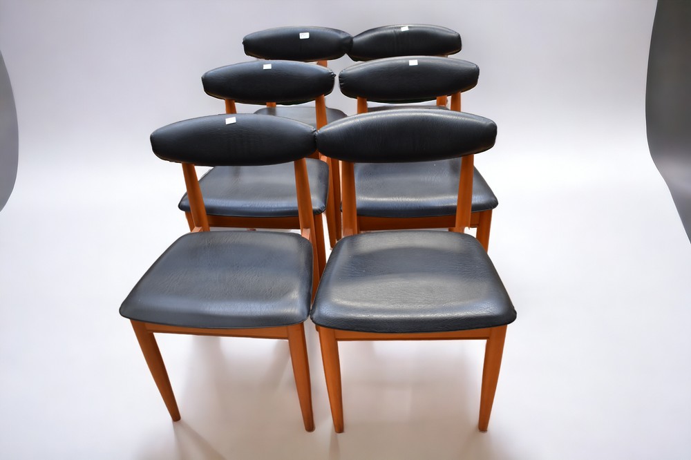 Six 1970s Schreiber dining chairs with black plastic back and seat rests.