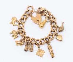 A Victorian 9ct gold charm bracelet comprising a textured Albert link bracelet, width approx 1cm,
