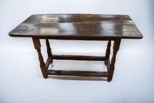 An early 18th Century oak table which used to be a gate leg drop leaf table.