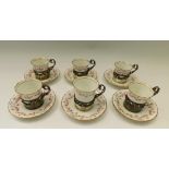 A set of six Royal Doulton rose garland and ribbon pattern silver-holder cups and saucers, cup