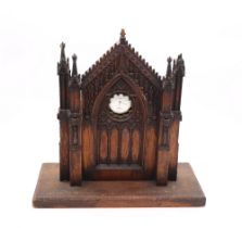 A late 19th/early 20th century Gothic Revival novelty pocket watch stand, with figural angular