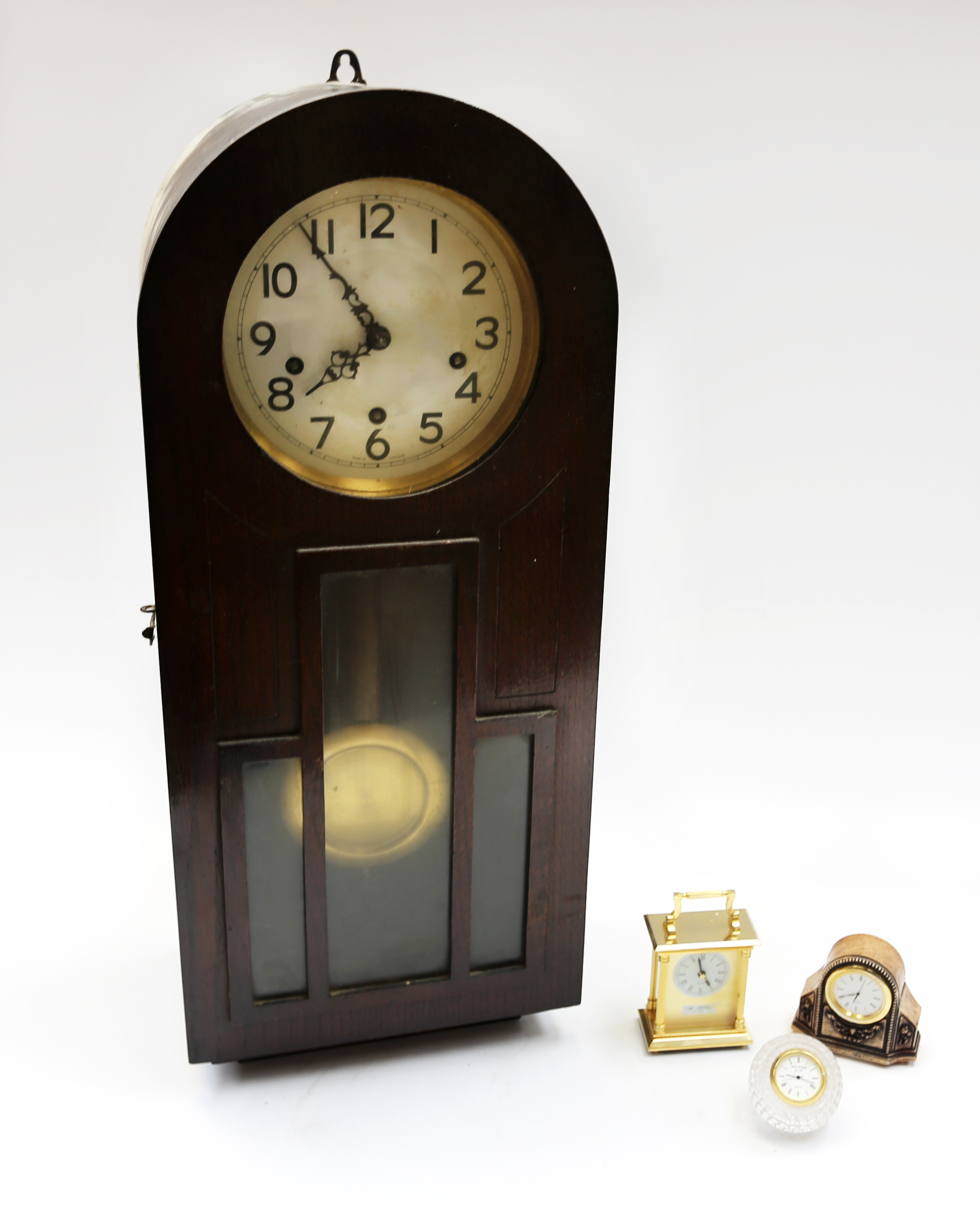 A 1930s 8 day wall clock along with three small mantle clocks.