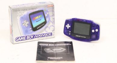 Game Boy: A boxed Nintendo Game Boy Advance console, transparent purple console with instruction