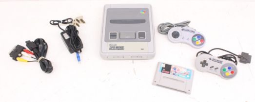 Nintendo: An unboxed Super Nintendo Entertainment System console, with one official Nintendo