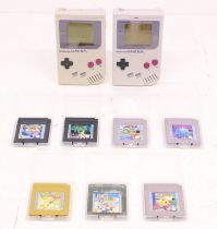 Game Boy: A pair of original Nintendo, Game Boy handheld consoles, Reference DMG-001. Together