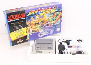 Nintendo: A boxed Super Nintendo Entertainment System (SNES) console, complete with power supply,
