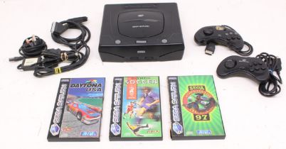 Sega: An unboxed Sega Saturn console, with power supply and two controllers; and a collection of