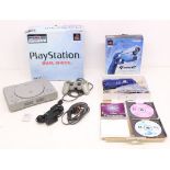 Playstation: A boxed Sony Playstation console, SCPH-9002B; together with a boxed Namco G-Con 2,