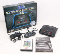 Sega: A boxed Sega Mega Drive II console, with two unofficial controllers, and instruction manual,