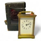 A brass carriage clock, 12cm tall with handle down in an associated leather case, in running order.