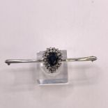 A sapphire and diamond bar brooch, Featuring a pear-shaped sapphire measuring 8.5mm x 6.1mm face