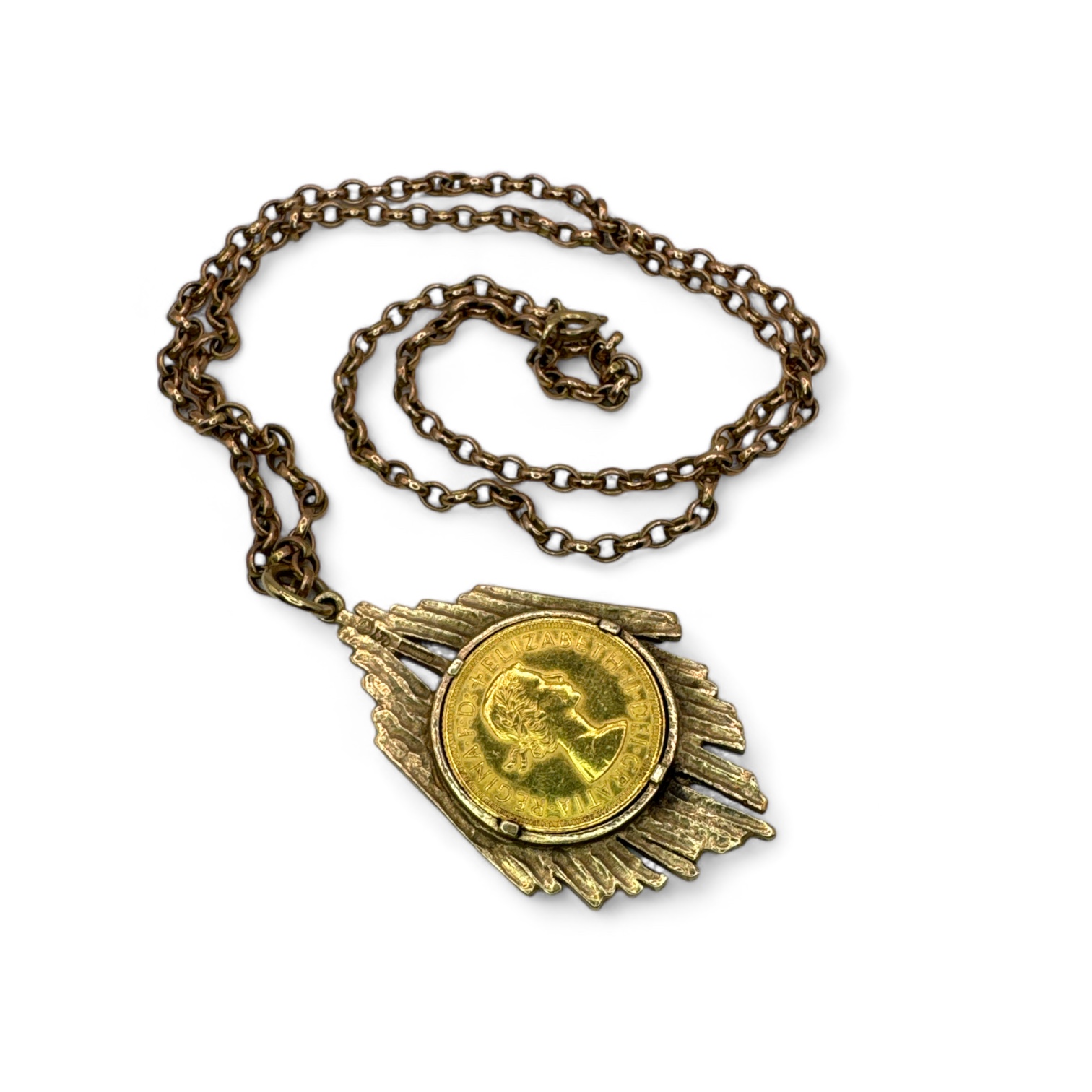 An Elizabeth II gold full Sovereign coin dated 1964 in a bark effect 9ct pendant mount on a gift